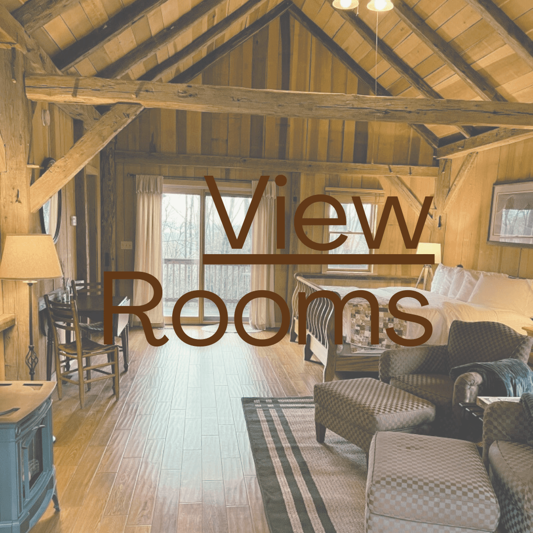 A cozy wooden interior of a room featuring a seating area and large windows.